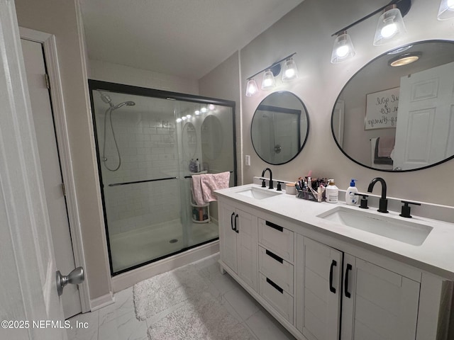 bathroom featuring vanity and a shower with shower door