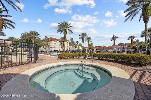 view of pool with a hot tub