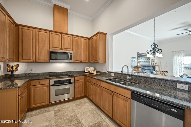 kitchen featuring crown molding, stainless steel appliances, sink, and hanging light fixtures