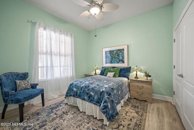 bedroom with hardwood / wood-style floors and ceiling fan