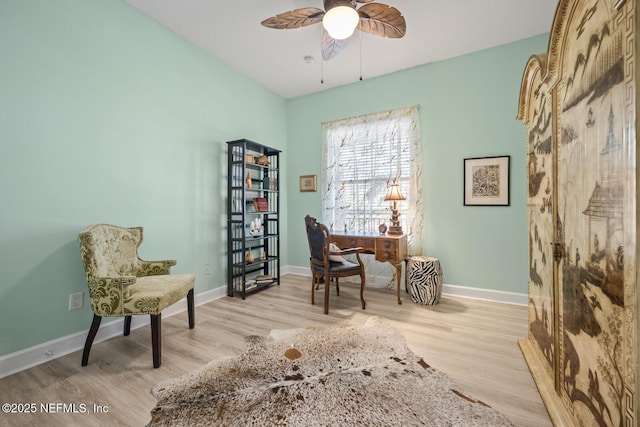 sitting room with ceiling fan and light hardwood / wood-style flooring