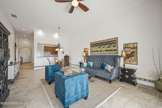 living room with ornamental molding, a baseboard heating unit, and ceiling fan with notable chandelier