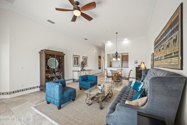 living room featuring light tile patterned floors, ornamental molding, ceiling fan, and a high ceiling