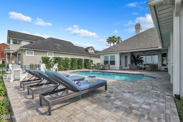 view of pool with an outdoor living space, central AC, and a patio area