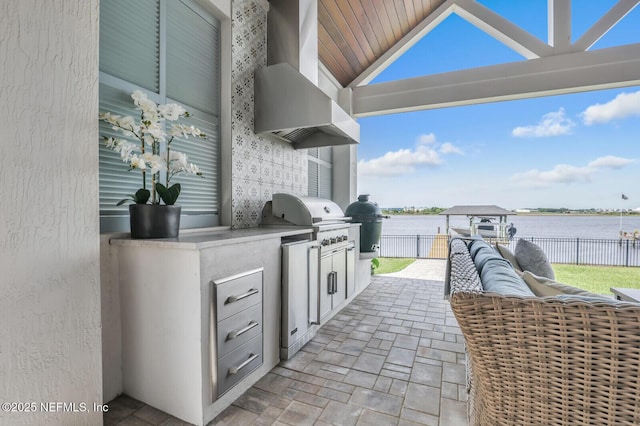 view of patio with a water view, an outdoor kitchen, area for grilling, and an outdoor hangout area