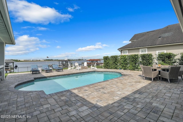 view of pool with a patio and a water view