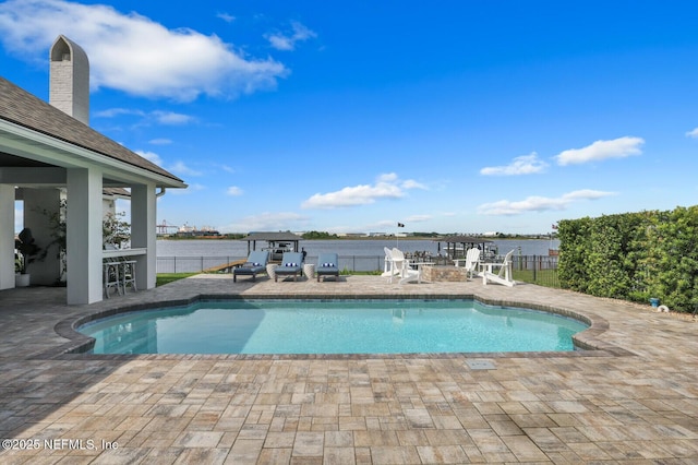 view of swimming pool with a water view, a pergola, and a patio area