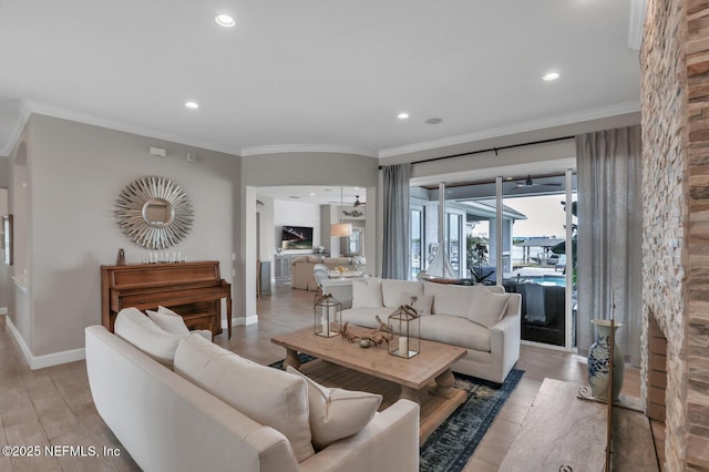 living room featuring crown molding and light hardwood / wood-style flooring