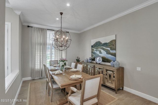 dining area with crown molding, light hardwood / wood-style floors, and a chandelier