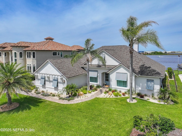 view of front facade featuring a water view and a front yard