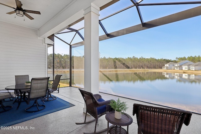 sunroom with a water view and ceiling fan