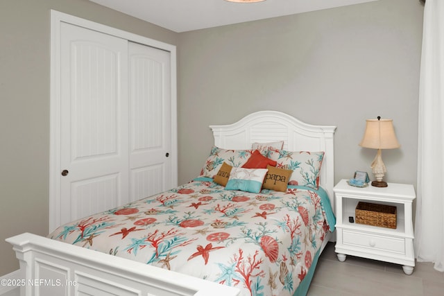 tiled bedroom with a closet