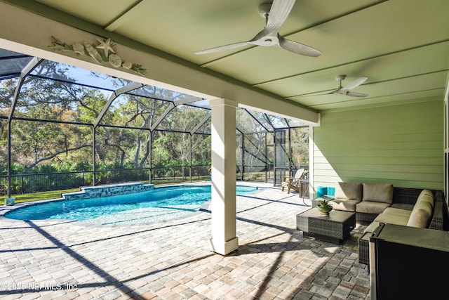 view of pool with outdoor lounge area, a patio area, ceiling fan, and a lanai