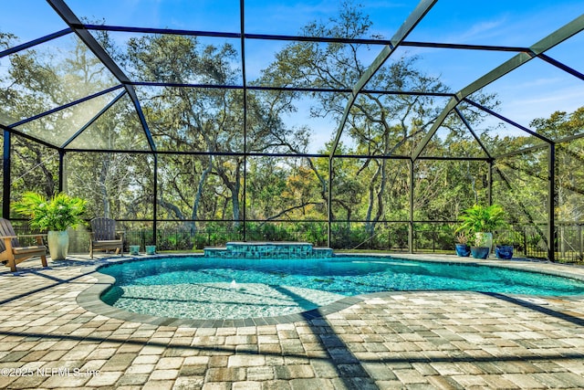 view of pool with a lanai and a patio