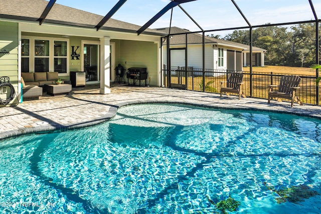 view of pool featuring a lanai, grilling area, outdoor lounge area, and a patio