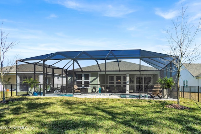 rear view of house featuring a fenced in pool, a patio, a lanai, and a lawn