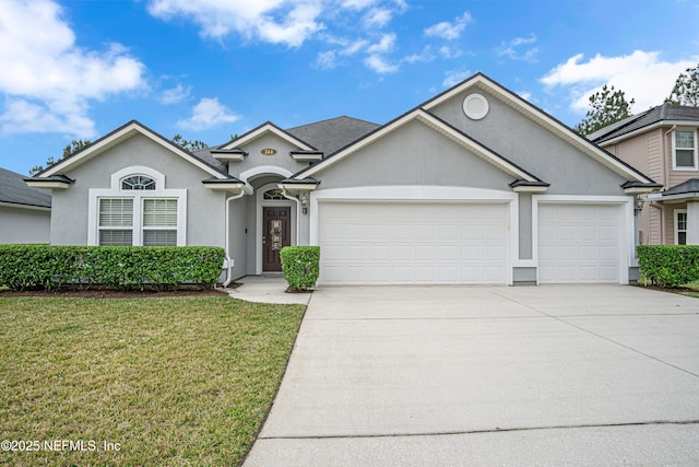 view of front of home featuring a garage and a front lawn