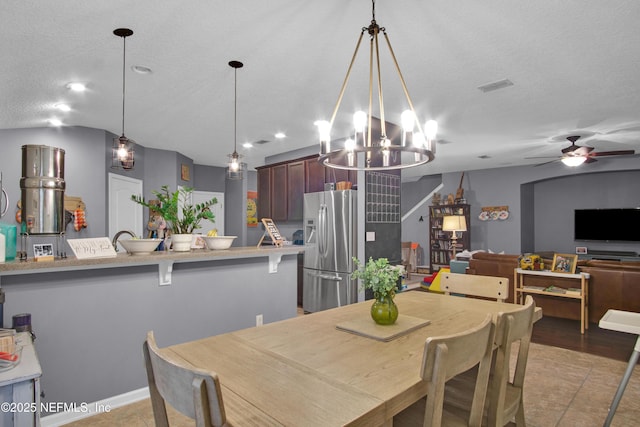 tiled dining room featuring ceiling fan and a textured ceiling