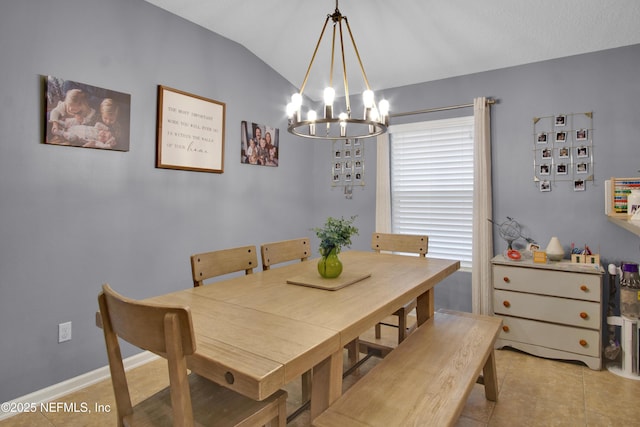 dining space with light tile patterned flooring, a chandelier, and vaulted ceiling