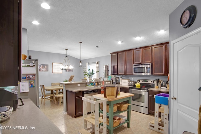 kitchen featuring an inviting chandelier, vaulted ceiling, hanging light fixtures, light tile patterned floors, and appliances with stainless steel finishes