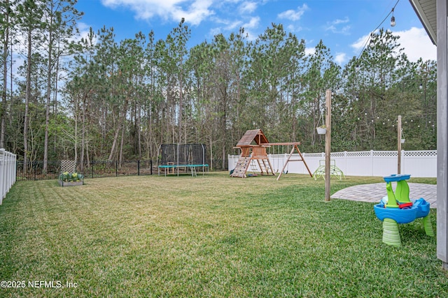 view of yard with a patio, a playground, and a trampoline