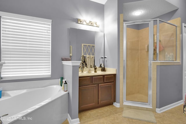 bathroom featuring vanity, tile patterned flooring, a textured ceiling, and separate shower and tub