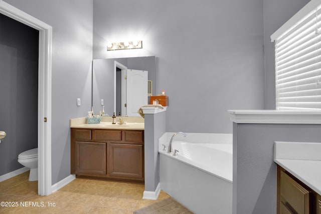 bathroom with vanity, toilet, tile patterned flooring, and a bathtub