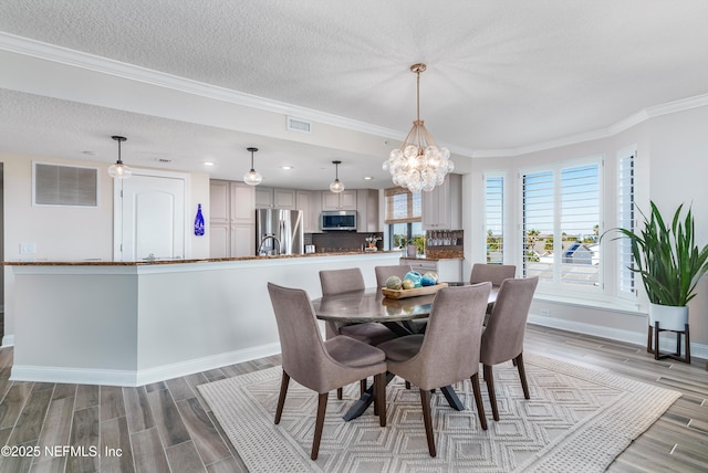 dining room with crown molding and a textured ceiling