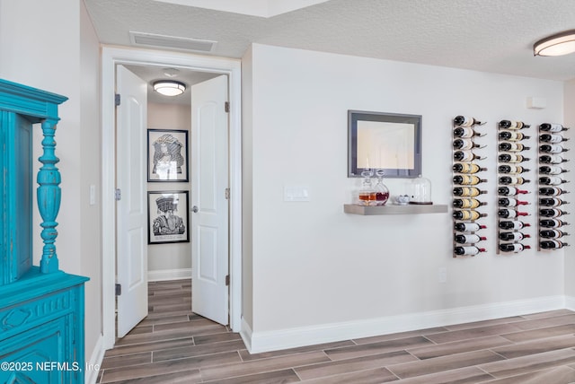 corridor featuring a textured ceiling