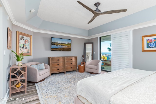 bedroom featuring access to exterior, hardwood / wood-style flooring, ornamental molding, and ceiling fan