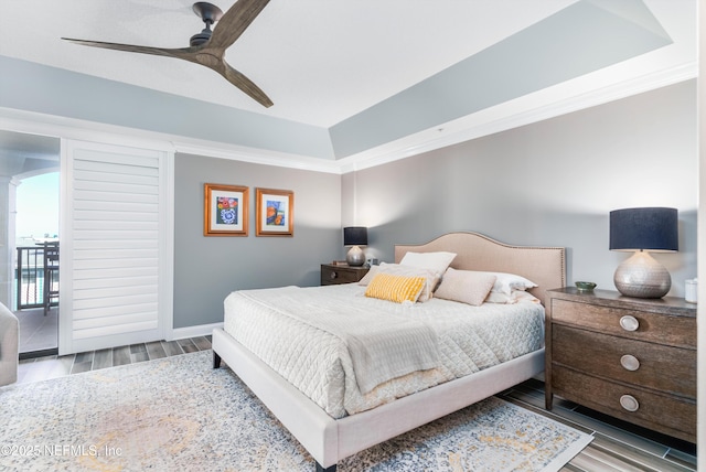 bedroom with hardwood / wood-style flooring, ornamental molding, and ceiling fan