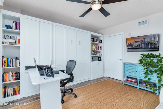 office area featuring a textured ceiling and ceiling fan