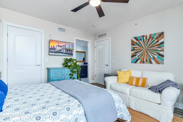 bedroom featuring ceiling fan and a textured ceiling