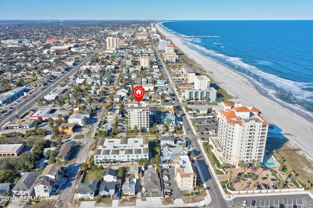 drone / aerial view with a water view and a view of the beach