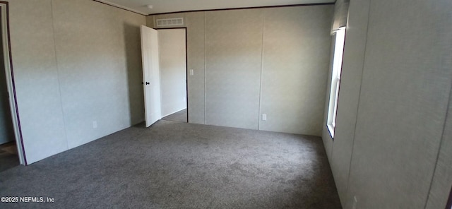 unfurnished bedroom featuring dark colored carpet