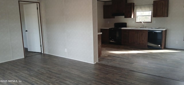 kitchen with sink, black appliances, dark hardwood / wood-style floors, and extractor fan