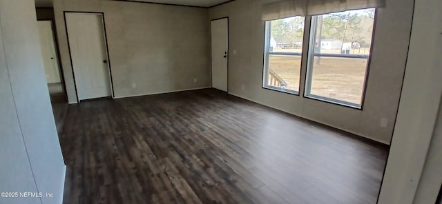 unfurnished room with dark hardwood / wood-style floors