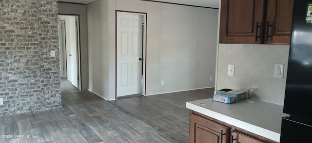 kitchen featuring black refrigerator and dark hardwood / wood-style floors