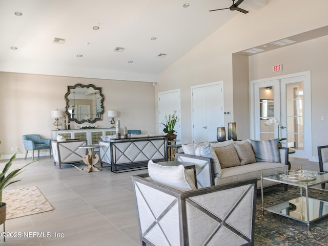 tiled living room with french doors, ceiling fan, and high vaulted ceiling