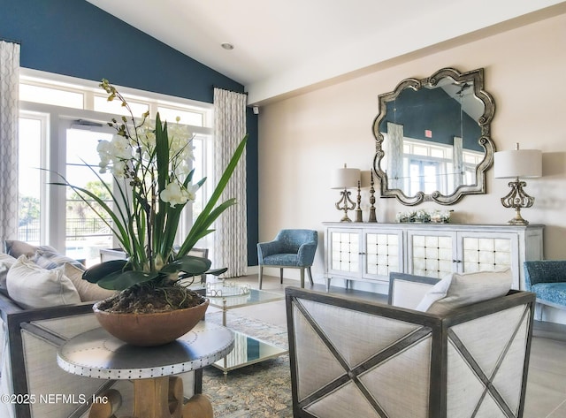 living room with plenty of natural light and vaulted ceiling