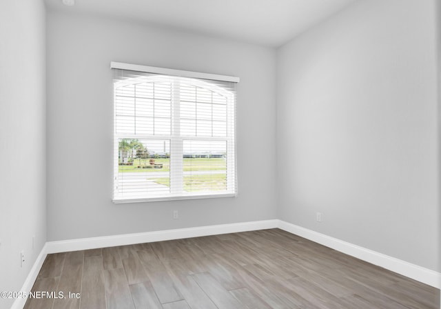 unfurnished room featuring hardwood / wood-style flooring