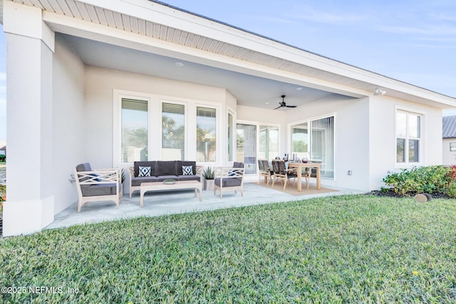 back of property with an outdoor living space, a patio area, ceiling fan, and a lawn