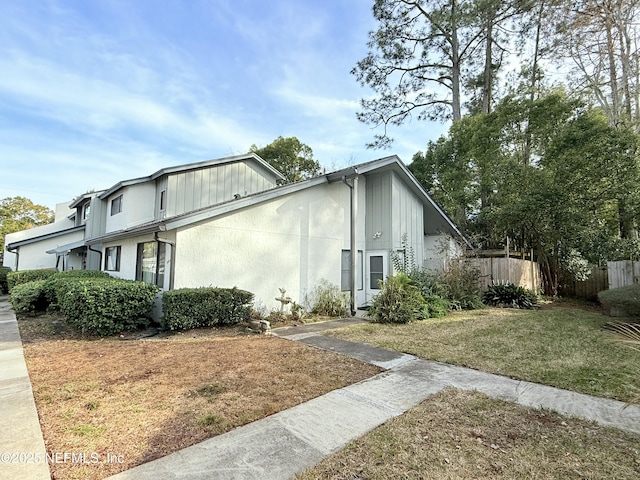 view of side of property with a lawn