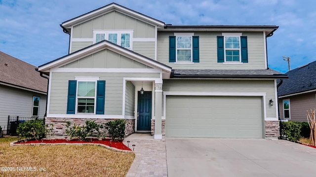 craftsman-style house featuring a garage and a front yard