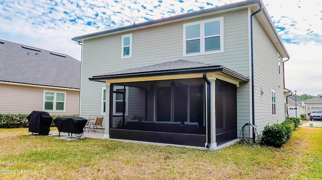 back of house featuring a patio, a sunroom, and a lawn