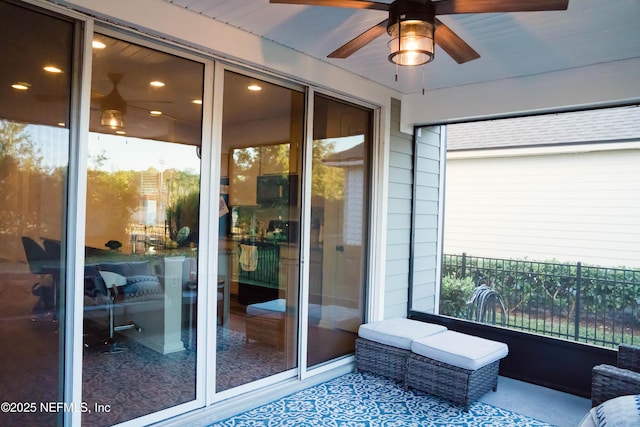 sunroom / solarium featuring ceiling fan