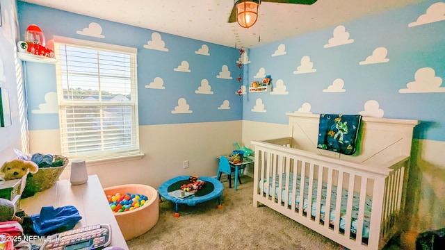 bedroom featuring a crib and carpet floors