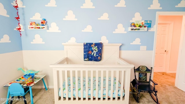 carpeted bedroom featuring a crib