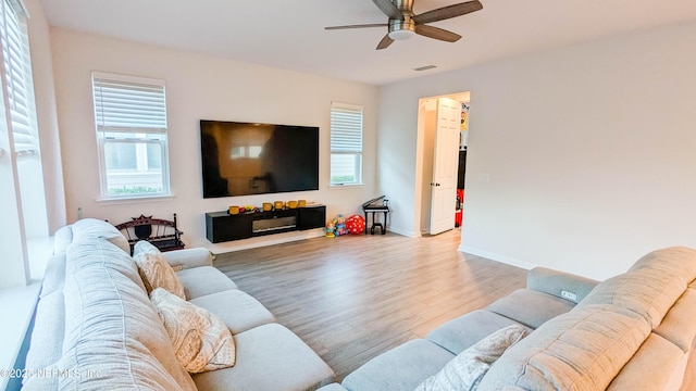 living room featuring wood-type flooring and ceiling fan