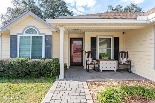 property entrance with a shingled roof